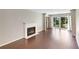 Bright living room with hardwood floors, fireplace, and sliding doors to a private balcony at 1312 Pine Heights Ne Dr, Atlanta, GA 30324
