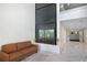 Modern lobby area with a comfortable couch and a view of the unique glass elevator at 1312 Pine Heights Ne Dr, Atlanta, GA 30324