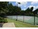 Outdoor tennis court surrounded by lush greenery, perfect for recreation at 1312 Pine Heights Ne Dr, Atlanta, GA 30324