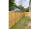 A spacious backyard featuring a new wooden privacy fence and lush green grass at 1754 Soapstone Ct, Decatur, GA 30034