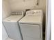 Laundry area features a white GE washer and dryer set, maximizing efficiency and space at 1754 Soapstone Ct, Decatur, GA 30034