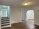 Open-concept living room with hardwood floors, staircase and archway at 1754 Soapstone Ct, Decatur, GA 30034