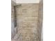 Modern shower featuring earth-toned tiling, pebble floor, and rainfall shower head panel at 1754 Soapstone Ct, Decatur, GA 30034