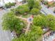 Aerial view of a city park with a fountain, trees, and walking paths surrounded by buildings at 281 Cherokee Ne St, Marietta, GA 30060