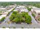 High aerial view overlooking a park square with mature trees surrounded by city buildings at 281 Cherokee Ne St, Marietta, GA 30060