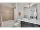 Neutral bathroom with a shower-tub combo, vanity with sink, and decorative mirror at 281 Cherokee Ne St, Marietta, GA 30060