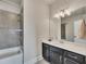 Well-lit bathroom featuring a shower-tub combo, vanity with sink, and modern lighting at 281 Cherokee Ne St, Marietta, GA 30060