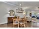 Dining area open to living space features hardwood floors, modern chandelier and comfortable seating at 281 Cherokee Ne St, Marietta, GA 30060