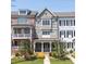 Charming townhome with a well-manicured lawn, inviting covered porch, and appealing architectural details at 281 Cherokee Ne St, Marietta, GA 30060