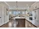 Bright kitchen with white cabinets, stainless steel appliances, an island, and hardwood floors at 281 Cherokee Ne St, Marietta, GA 30060