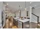 Open concept kitchen with island sink, seating, stainless appliances, and access to dining and living areas at 281 Cherokee Ne St, Marietta, GA 30060