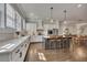 Bright kitchen boasts white cabinets, quartz counters, island with seating, and hardwood floors at 281 Cherokee Ne St, Marietta, GA 30060