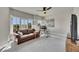 Comfortable living room with a brown leather sofa, desk, and large windows with plantation shutters at 281 Cherokee Ne St, Marietta, GA 30060