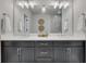 Modern bathroom with dual vanities, sleek cabinets, large mirror, and contemporary lighting fixtures at 281 Cherokee Ne St, Marietta, GA 30060