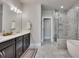 Luxurious main bathroom with dual vanities, soaking tub, and a glass-enclosed shower at 281 Cherokee Ne St, Marietta, GA 30060