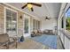 Charming screened-in porch featuring ample seating, a ceiling fan, and a brick exterior at 281 Cherokee Ne St, Marietta, GA 30060