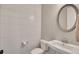 Stylish powder room featuring shiplap accent wall, pedestal sink, oval mirror, and modern fixtures at 281 Cherokee Ne St, Marietta, GA 30060