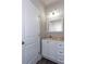 Cozy half bathroom with white cabinets, decorative fixtures, and neutral paint at 3352 Landings South Dr, Atlanta, GA 30331
