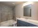 Bathroom with a tub-shower combo, gray tiling, and a blue vanity with a white countertop at 3352 Landings South Dr, Atlanta, GA 30331