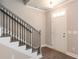 Inviting entryway with staircase, modern floors, and natural light shining through the front door at 3352 Landings South Dr, Atlanta, GA 30331