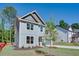 Side view of a modern two-story home featuring gray siding and a well-maintained lawn with landscaping at 3352 Landings South Dr, Atlanta, GA 30331