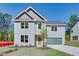 Charming two-story home with gray siding, attached garage, and well manicured lawn on a sunny day at 3352 Landings South Dr, Atlanta, GA 30331