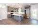 Modern kitchen featuring gray cabinets, marble countertops, stainless steel appliances, and stylish pendant lighting at 3352 Landings South Dr, Atlanta, GA 30331
