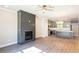 Open-concept living room featuring a modern fireplace, gray walls, ceiling fan, and hardwood flooring at 3352 Landings South Dr, Atlanta, GA 30331