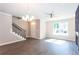 Bright living room with staircase, hardwood floors, a ceiling fan, and natural light coming through the window at 3352 Landings South Dr, Atlanta, GA 30331