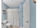 Compact bathroom with blue walls, featuring a toilet, and a white shower curtain at 3655 Habersham Ne Rd # 244B, Atlanta, GA 30305