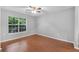 Bright bedroom with hardwood floors and a large window overlooking the green landscape at 3655 Habersham Ne Rd # 244B, Atlanta, GA 30305