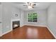 Bedroom featuring a fireplace, hardwood floors, and a window with natural light at 3655 Habersham Ne Rd # 244B, Atlanta, GA 30305