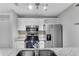 Renovated kitchen featuring stainless steel appliances, sleek white cabinets, and granite countertops at 3655 Habersham Ne Rd # 244B, Atlanta, GA 30305