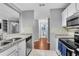 Well-lit kitchen with stainless appliances, granite counters, and view into other rooms at 3655 Habersham Ne Rd # 244B, Atlanta, GA 30305
