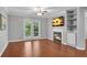 Open-concept living room featuring wood flooring, a cozy fireplace, and balcony access at 3655 Habersham Ne Rd # 244B, Atlanta, GA 30305
