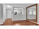 Open-concept living room with wood floors, open to the kitchen and featuring a large decorative mirror at 3655 Habersham Ne Rd # 244B, Atlanta, GA 30305