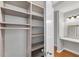 Walk-in closet featuring built-in shelving units and access to a vanity area at 3655 Habersham Ne Rd # 244B, Atlanta, GA 30305