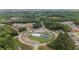 Aerial shot of community with pool, clubhouse, and tennis courts amid lush wooded surroundings at 438 Southland Cir, Canton, GA 30115