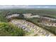 A panoramic aerial view presents an extensive neighborhood bordered by a dense forest, perfect for nature lovers at 438 Southland Cir, Canton, GA 30115