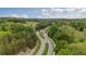 Aerial view of a gated community entrance amidst lush greenery and winding roads, creating a serene environment at 438 Southland Cir, Canton, GA 30115