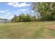 Expansive backyard featuring lush green grass, mature trees, and secure fencing for privacy and enjoyment at 438 Southland Cir, Canton, GA 30115