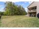 Beautiful home featuring a large, fenced backyard surrounded by lush trees and a covered deck at 438 Southland Cir, Canton, GA 30115