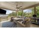 Relaxing covered patio with a ceiling fan, stylish furniture, grill, and scenic views at 438 Southland Cir, Canton, GA 30115