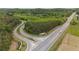 Impressive community entrance with elegant signage, roundabout, and surrounding greenery along a major road at 438 Southland Cir, Canton, GA 30115