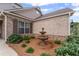 Elegant three-tiered fountain surrounded by lush landscaping, enhancing the exterior appeal at 438 Southland Cir, Canton, GA 30115