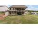 Picture of a spacious home with a fenced backyard, covered patio, and lush greenery at 438 Southland Cir, Canton, GA 30115