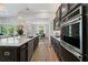 Modern kitchen and open dining area, showcasing dark cabinetry and pendant lighting at 438 Southland Cir, Canton, GA 30115