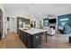 Open-concept kitchen with a large island and view into a living room with a fireplace at 438 Southland Cir, Canton, GA 30115