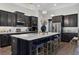New kitchen with an island, dark cabinets, marble countertops, and stainless steel appliances at 438 Southland Cir, Canton, GA 30115