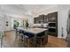 Spacious kitchen featuring a large island with seating, stainless steel appliances, and stylish pendant lighting at 438 Southland Cir, Canton, GA 30115